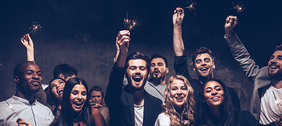 Party with friends. Group of cheerful young people carrying sparklers and champagne flutes; Shutterstock ID 499219201; PO: 123