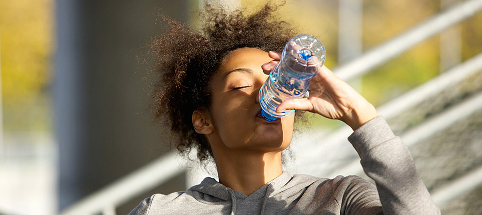 Close up portrait of a young sports woman drinking water from bottle; Shutterstock ID 243827989; PO: 123
