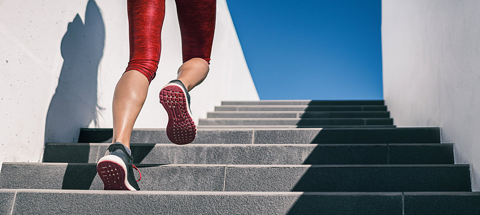 Cardio runner woman going up step of stairs at outdoor staircase for uphill hiit workout training exercise. Banner panoramic running shoes closeup.; Shutterstock ID 1477196138; PO: 123