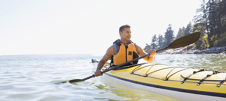 14 Sep 2014 --- Man kayaking on sunny ocean --- Image by © Hero Images Inc./Hero Images Inc./Corbis