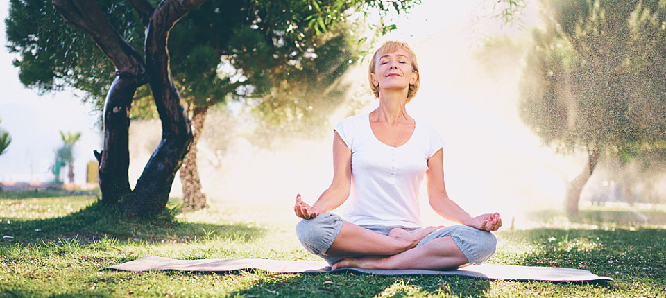 Yoga at park. Senior woman in lotus pose sitting on green grass. Concept of calm and meditation.; Shutterstock ID 581710201; Other: ; Purchase Order: 123; Client/Licensee: ; Job: 